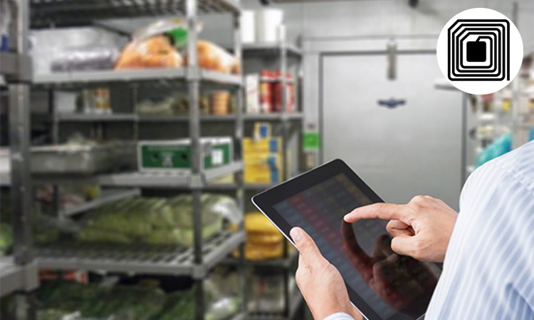 He is using a tablet to confirm the stock quantity of RFID tagged food items on hand