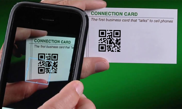 Using a smartphone to scan a business card with a qr code label provides faster access to a person's contact information