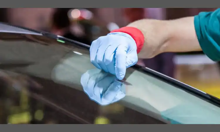 This worker is removing the residue left behind during the RFID tag removal process