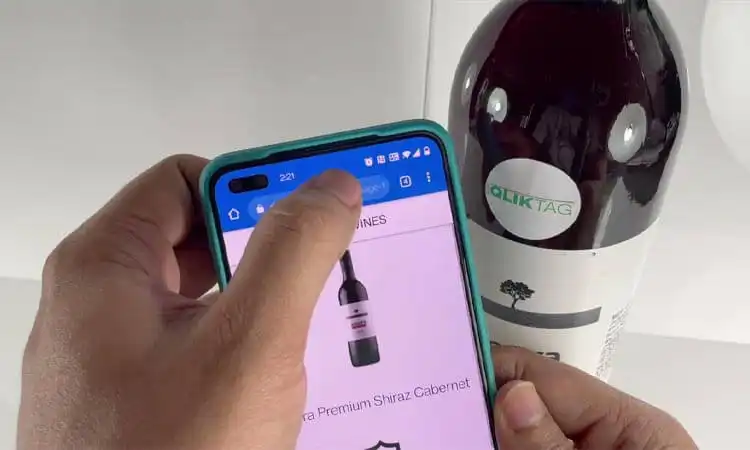 He is getting information about the wine carried by the RFID package on the bottle