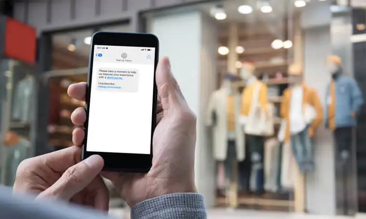 I clienti ricevono messaggi promozionali inviati dalla tecnologia di marketing di prossimità del negozio di abbigliamento